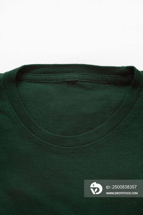 Close up shot of folded dark green t-shirt with white background