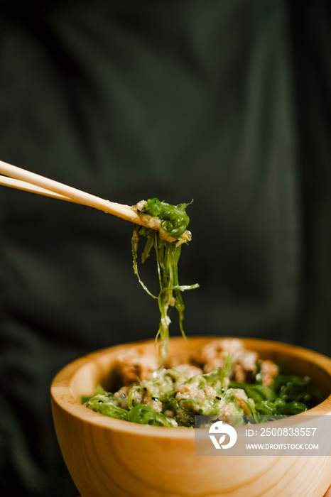 Asian seaweed with walnut sauce in a bowl