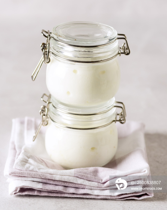 Two Portions of Fresh Natural Organic Yogurt in a Glass Jars on Napkin Homemade Greek Yogurt Healthy Breakfast Vertical