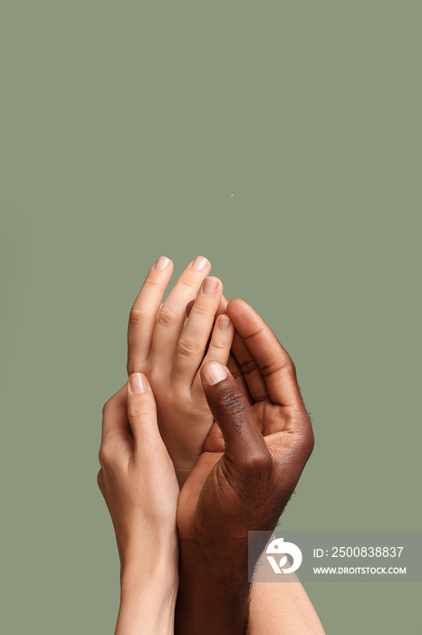 Hands of Caucasian woman and African-American man on color background. Racism concept