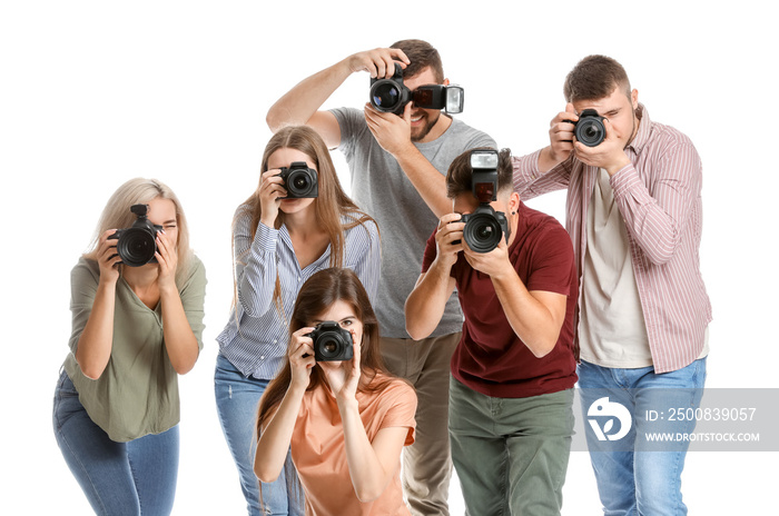 Group of young photographers on white background