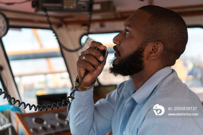 Navigator, pilot, captain part of the crew of the boat that performs daily tasks with VHF radio