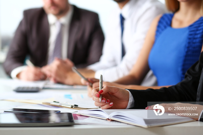 Female clerk arm make marks in notepad with silver pen closeup at office workplace. Audit paperwork financial inspector assistant fill survey form for job offer management training course discussion