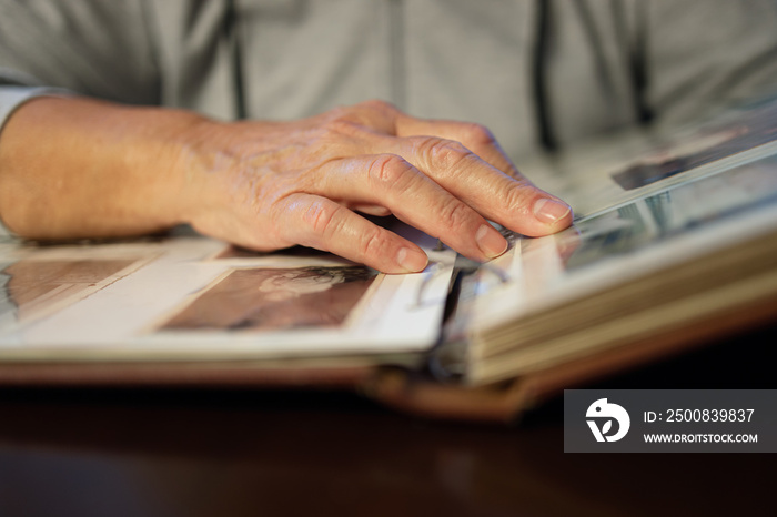 Old woman looking at family photo album