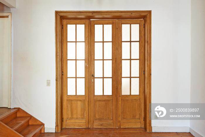 Interior aged wooden door with glasses frames