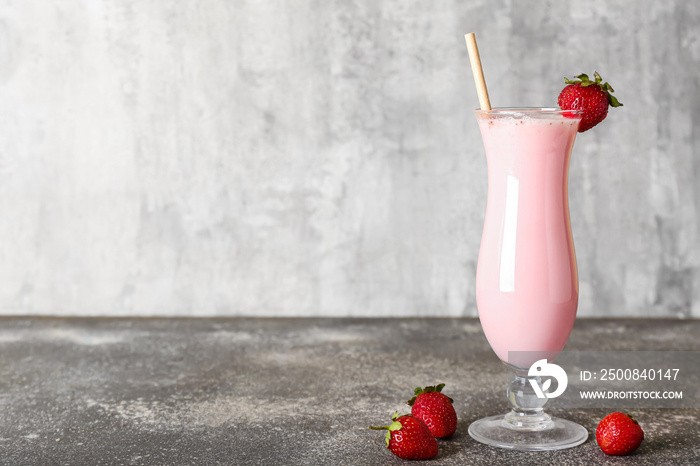 Glass of strawberry Pina Colada cocktail on grunge background