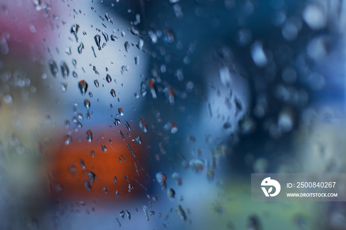 Raindrops falling on glass, abstract blurs - monsoon stock image of Kolkata (formerly Calcutta) city , West Bengal, India