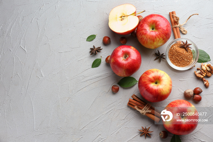 Fresh ripe apples and cinnamon on light background