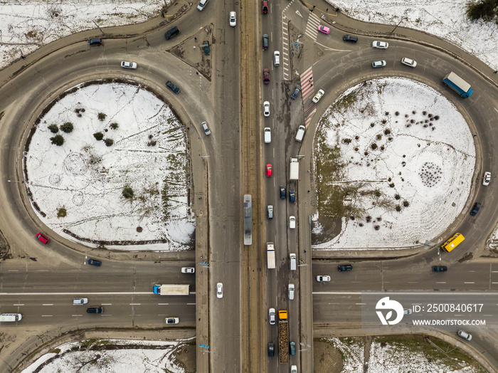 Kyiv road junction in light snow. Aerial drone view. Winter cloudy morning.