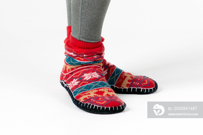 cropped view of woman wearing beautiful red socks with christmas print isolated on white