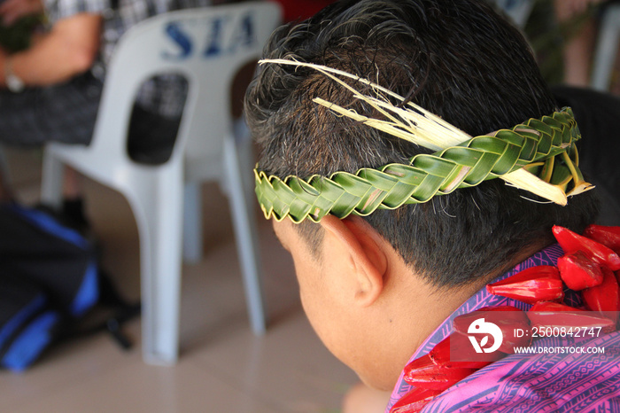 Weaving a headband by using the local palm trees. Its part of the cultural program in Samoan Cultural Village , Apia.