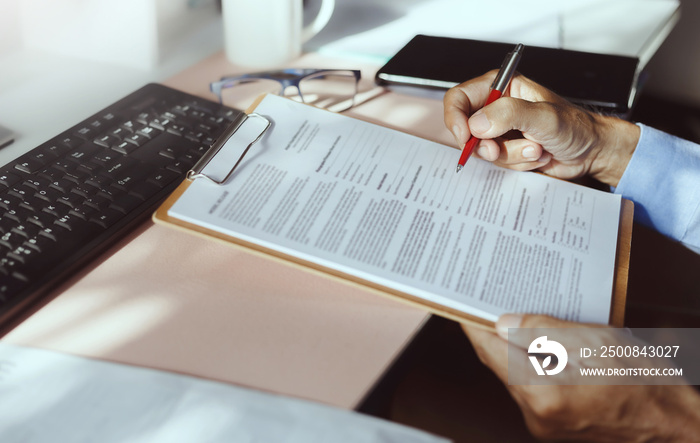 Close-up view on desk office, businessman reading a contract of investment or insurance, legal agreement before signing, Starting successful partnership with entrepreneur or companie