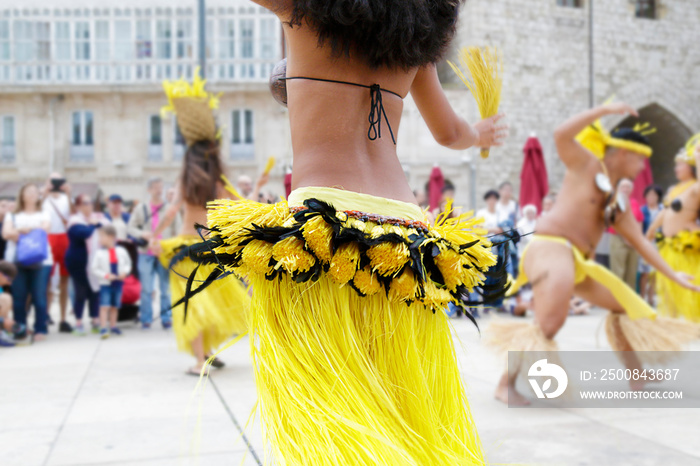 Dancers dancing and wearing the traditional folk costume from Tahiti, French Polynesia.