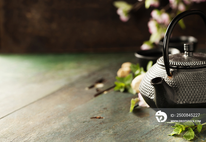 Tea concept, cups with tea and traditional teapot decorated with