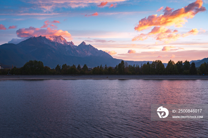 sunrise over lake and snow mountain