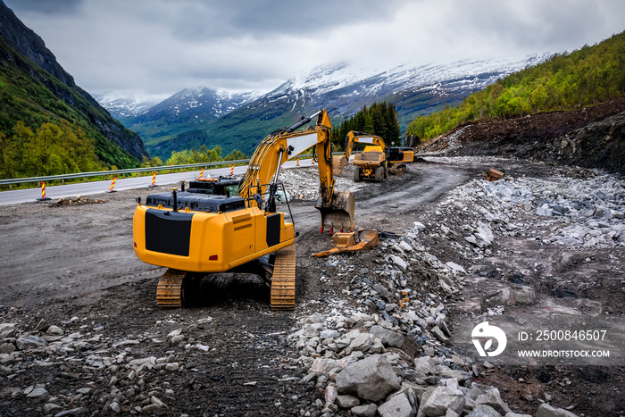 Industrial truck loader excavator moving earth and unloading into a dumper truck