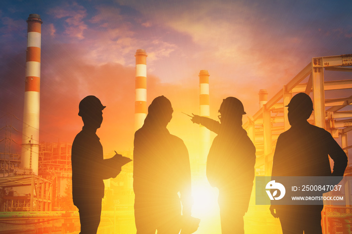 Silhouette Teams engineer looking construction worker in a  Power plant station at sunset