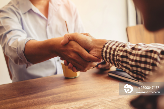 Close-up Shake hands lawyers in office. Counseling and Give an advice between private and government officials to find a fair settlement. instagram style filter