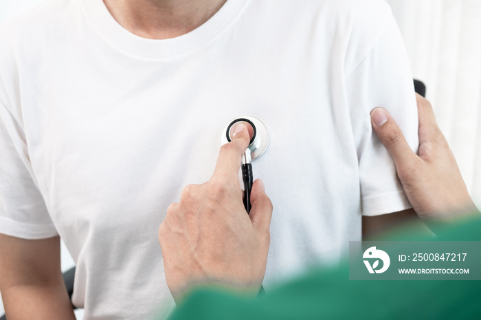 The doctor is measuring the heart rate of the patient by stethoscope in the hospital.