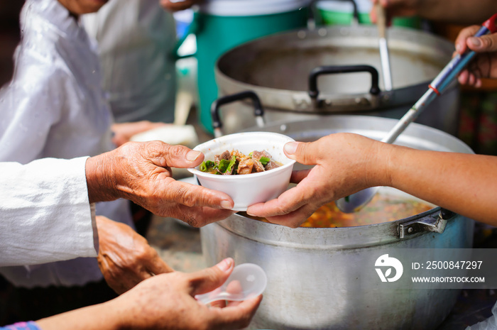 Food needs of the poor in society Help with Food Donation : Homeless people pick up charity food from the food donors in society : The concept of the beggar problem on earth