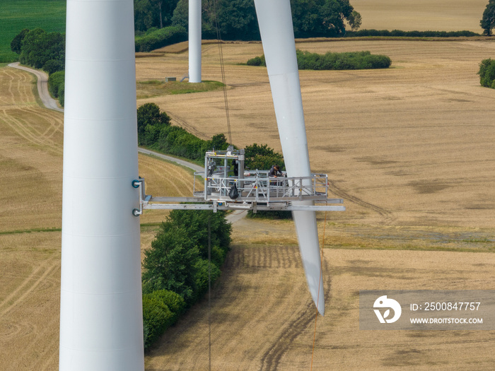 Inspection engineer preparing and progress check of a wind turbine by wind farm. Repair work on the blades of a windmill for electric power production.