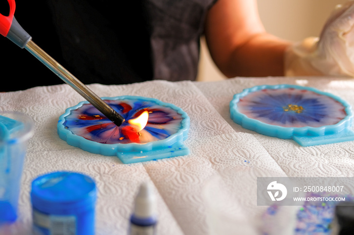 Woman making epoxy resin arts and crafts.