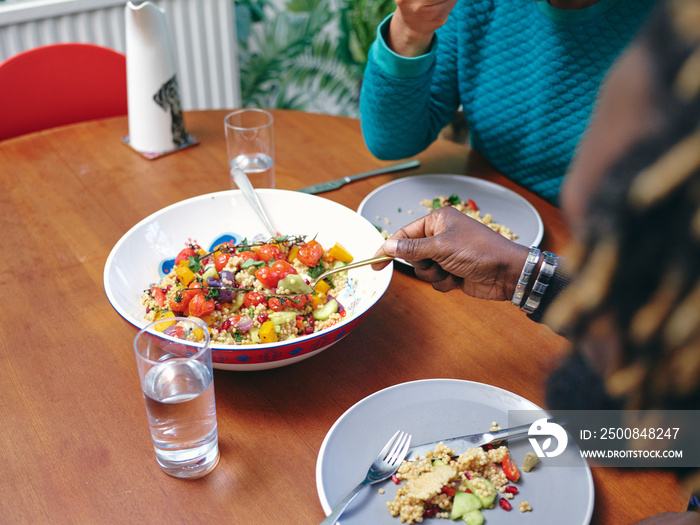 Couple eating lunch at home, close up