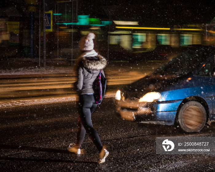 Woman on zebra crossing at night