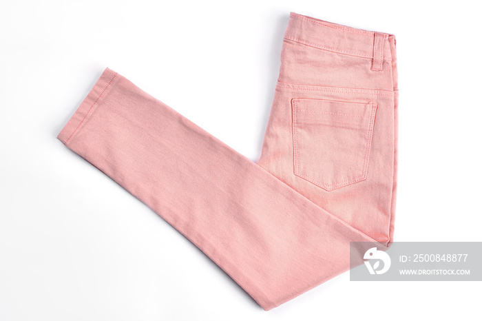 Female casual peach color jeans. Girls new middle waist trousers folded on white background. Female spring or summer skinny pants on sale.