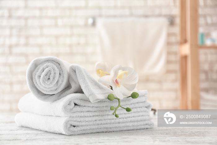 Towels with flowers on light table