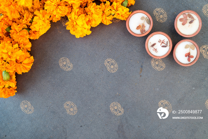 Wax diyas made of clay with marigold flowers for hindu religious celebration and festivity