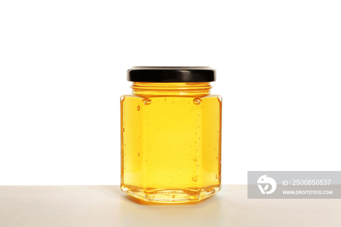 Jar of sweet honey on white background