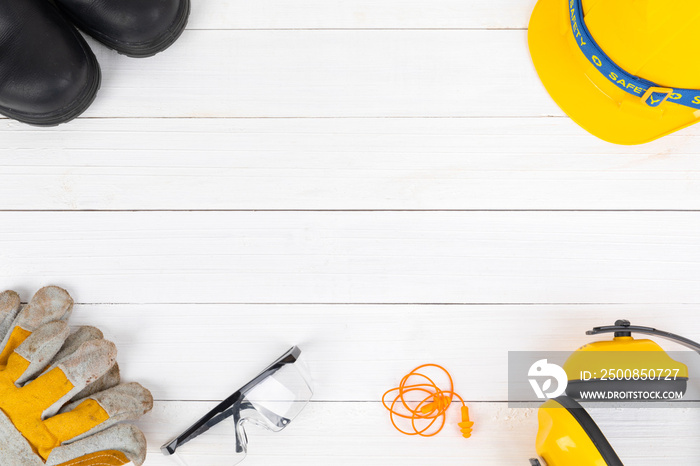 Banner image of construction safety equipment flat lay on white wooden.