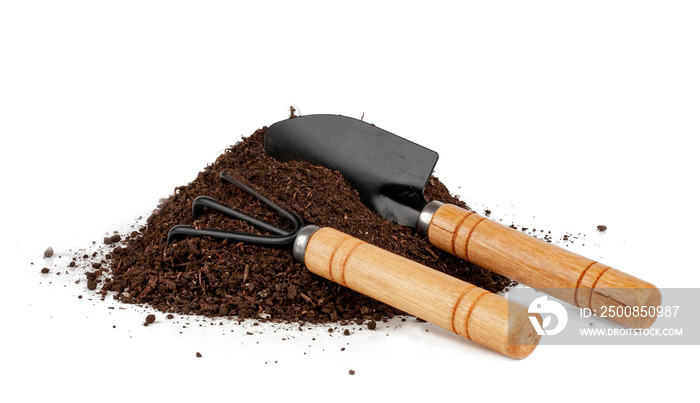 Garden tools in soil isolated on a white background