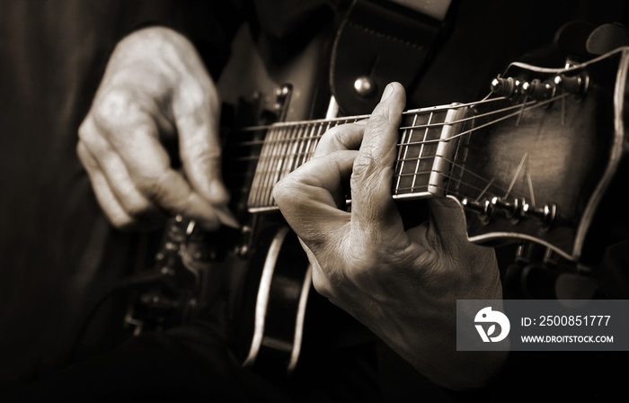 Guitarist hands and guitar close up. playing electric guitar. copy spaces. black and white.