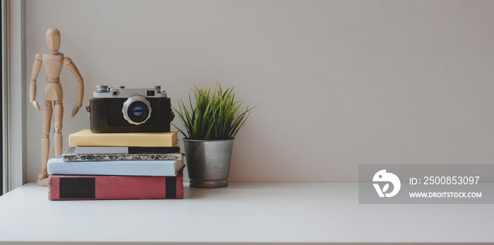 Comfortable workspace with vintage camera and office supplies with copy space