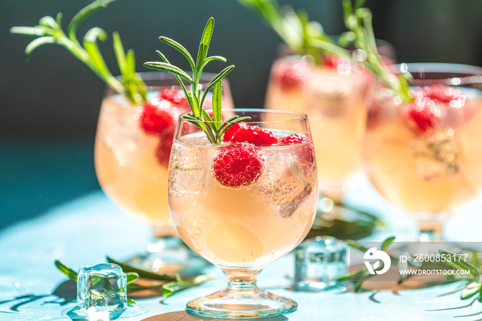 Close up mix berries ice soda with thyme in a transparent glass on white table at cafe