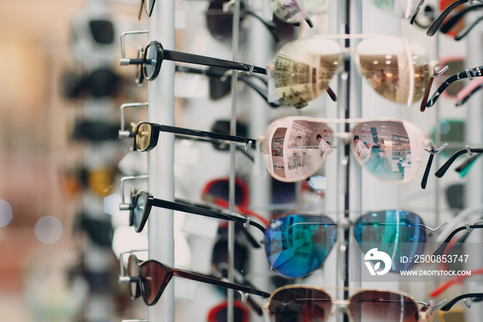 Glasses on the counter in the optics store. Eyeglasses goggles sunglasses on shop