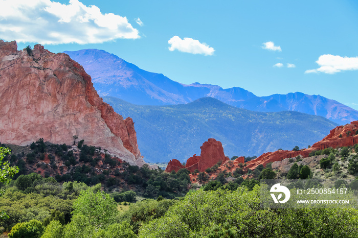 Red sandstone formations and bluffs near Colorado Springs with the distant blue Rocky Mountains in the background - selective focus