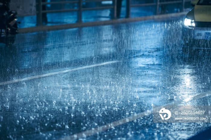 Cars driving on wet road in the rain with headlights