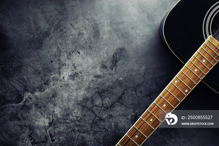 Guitar and accessories on a stone background. Desk musician, headphones, microphone.