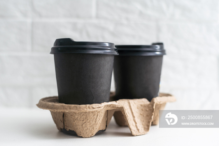 Two take-out coffee in holder. Isolated on a white.