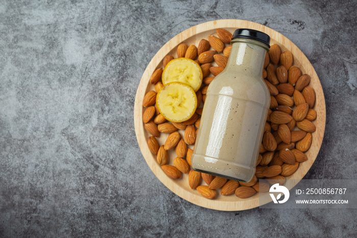 Banana almond smoothie in bottle on dark background