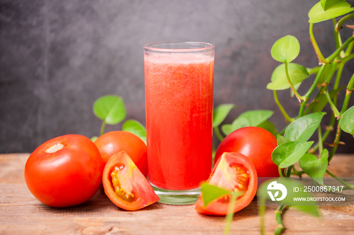 Fresh tomato juice on wooden table