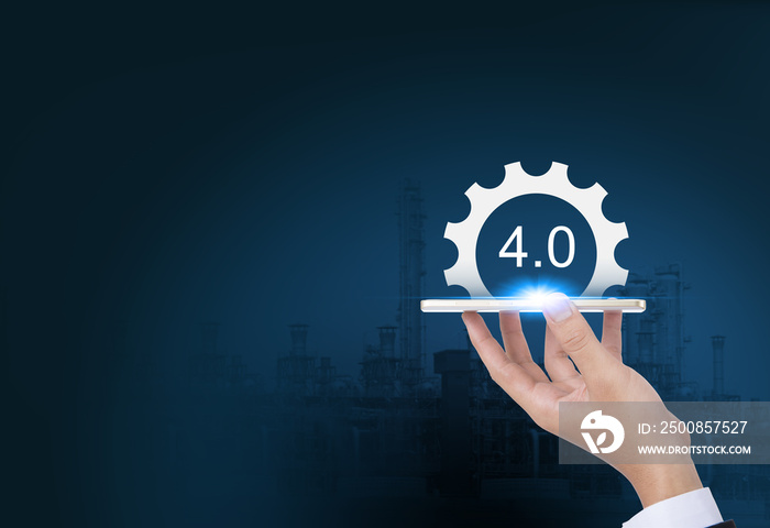 Industrial 4.0 Cyber Physical Systems concept, Gears industry4.0 icons on smart phone by business hand with oil refinery industry background.