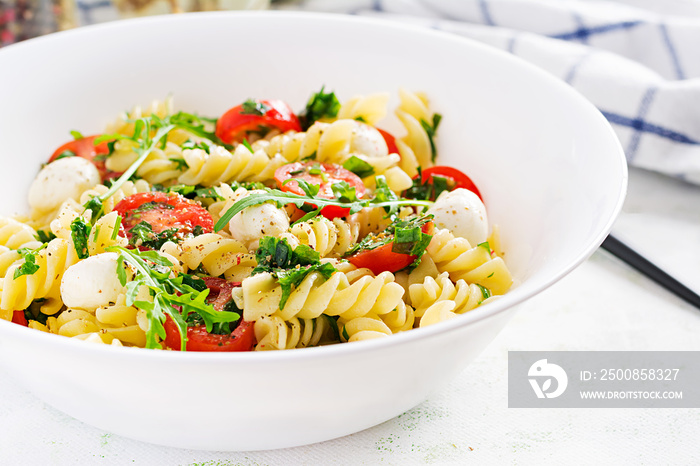 Pasta salad. Fusilli Pasta - Caprese salad with tomato, mozzarella and basil.