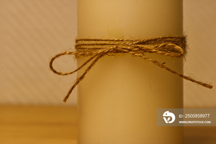 candle with raffia loop