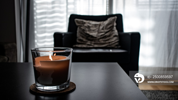 A candle in a black table