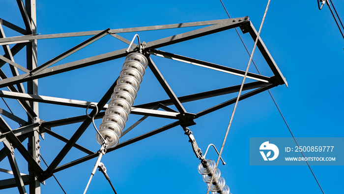 Electricity pylon insulator hanging from a towers crossbeam