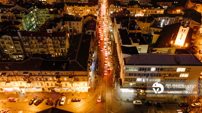 View from drone to night Kyiv city with cars movement on street.